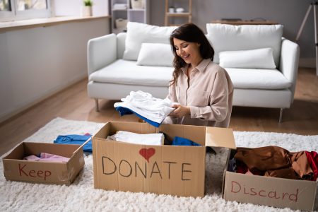 Sorting clothing for donation during a home declutter